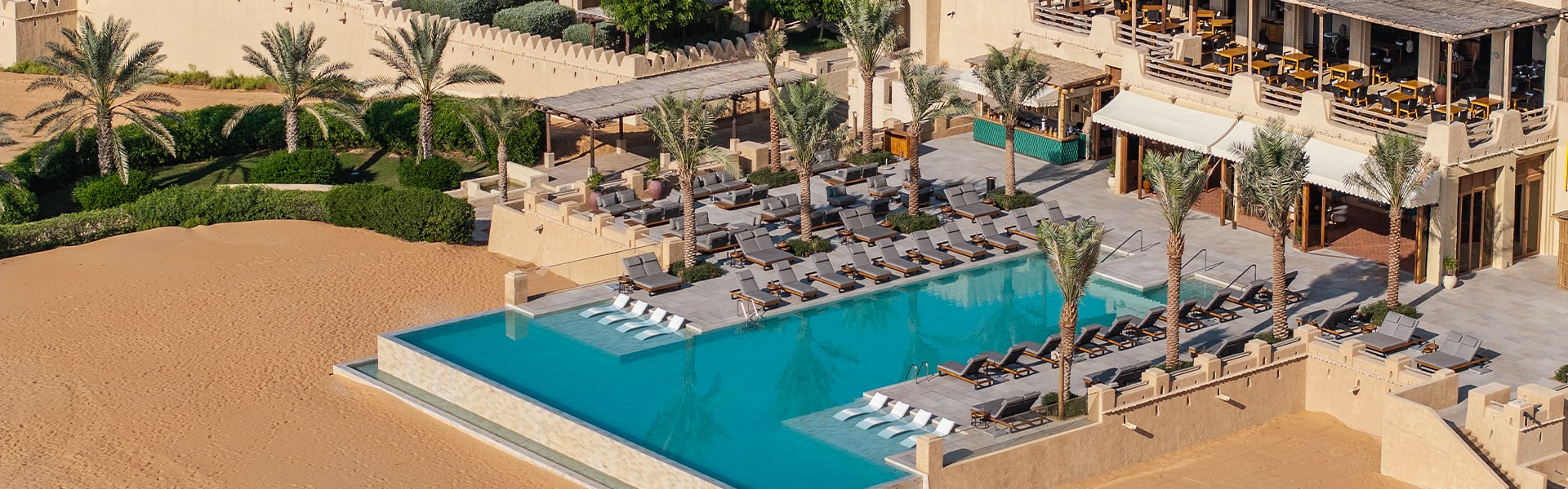 https://assets.anantara.com/image/upload/q_auto%2Cf_auto/media/minor/anantara/images/qasr-al-sarab-desert-resort-by-anantara/leisure/infinity-pool/qasr_al_sarab_desert_resort_by_anantara_infinity_pool_aerial_with_resort1920x600.jpg