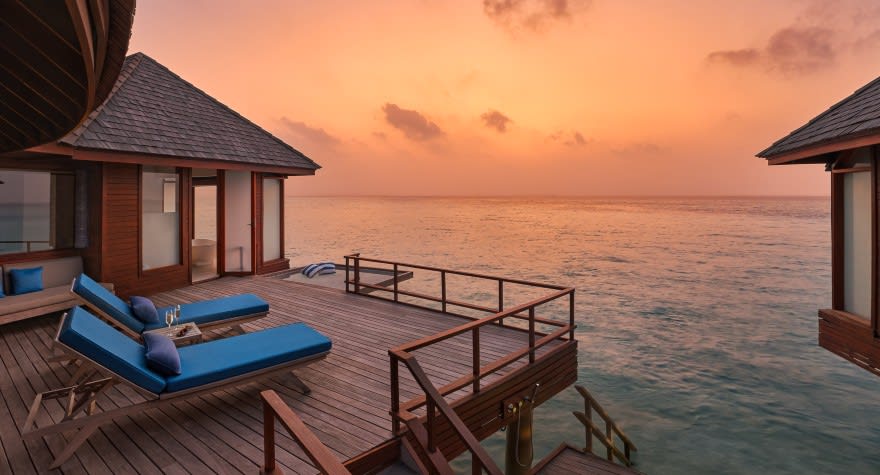 Sunset Over Water Suite Deck with Loungers at Anantara Dhigu Maldives Resort