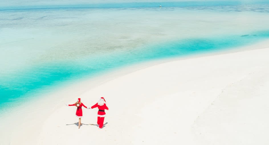 Santa strolling on the sandy beach of Anantara Dhigu Maldives Resort