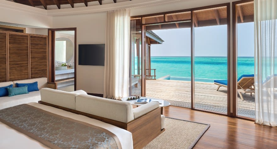 Deluxe Sunset Over Water Pool Villa bedroom at Anantara Dhigu Maldives Resort