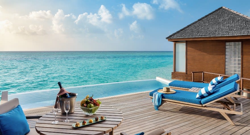 Sunset Over Water Pool Suite Deck with Loungers at Anantara Dhigu Maldives Resort