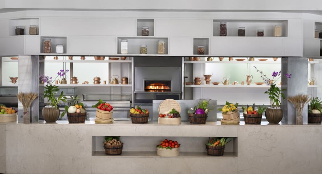 Cumin Restaurant at Anantara Veli Maldives with open kitchen and fresh produce display.