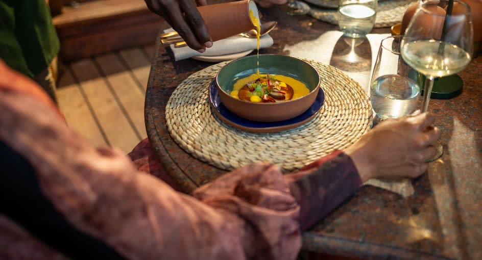 Garnishing a dish at all-day dining at Anantara Tented Camp Kafue River