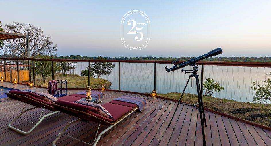Deck with sunbeds, telescope and river view at Anantara Tented Camp Kafue River