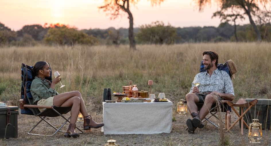 Bush dinner with a candlelit table set up at Anantara Tented Camp Kafue River