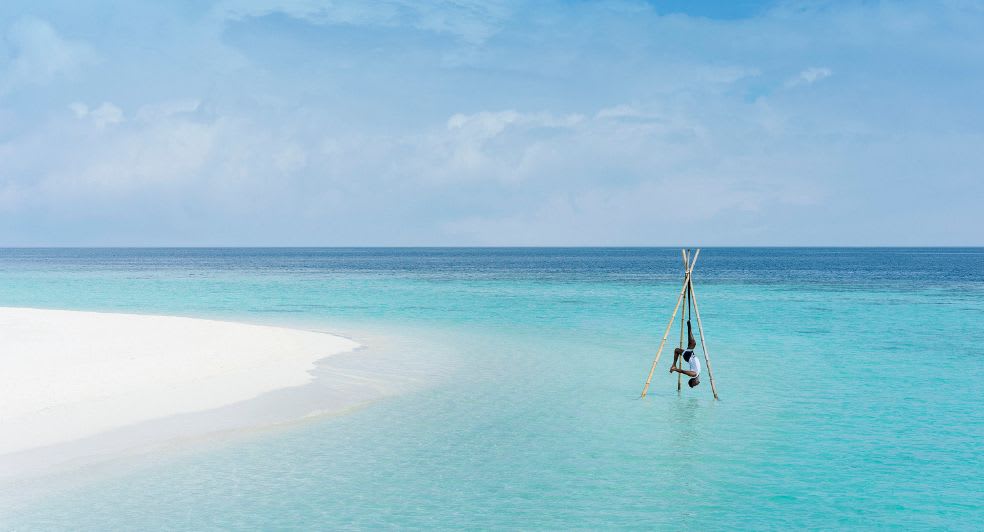 Yoga on the beach at Anantara Kihavah Maldives