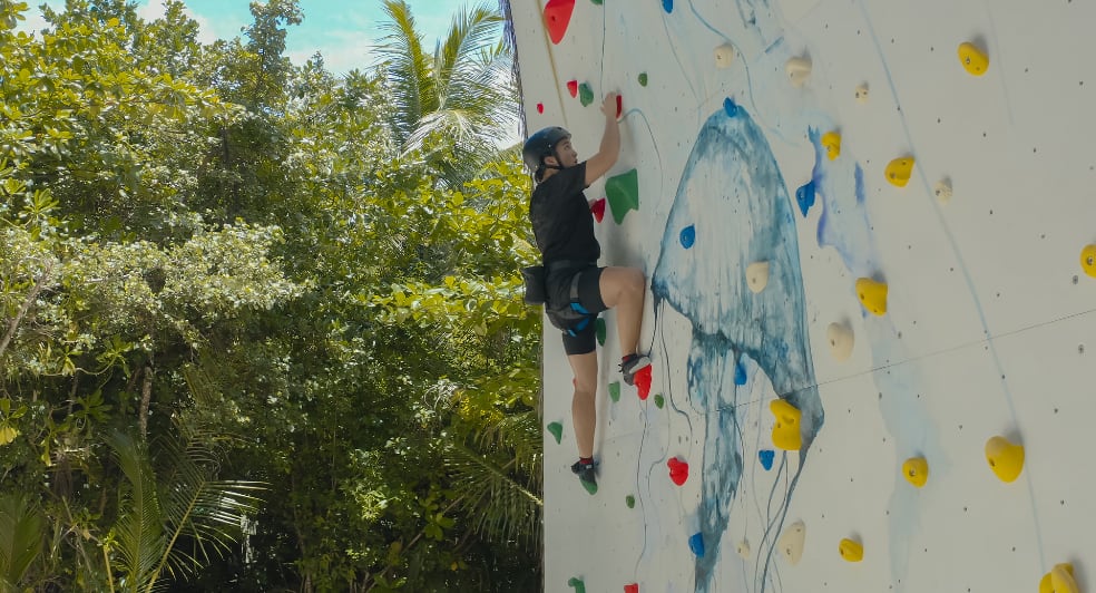 Climbing on the wall at Anantara Kihavah Maldives