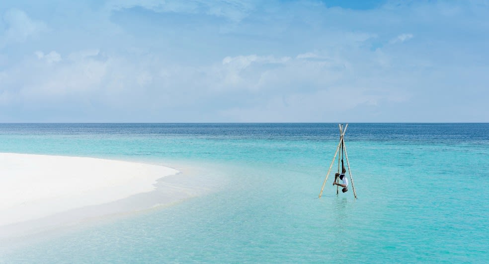 Yoga in the ocean at Anantara Kihavah Maldives