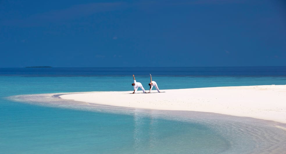 Yoga on the beach at Anantara Kihavah