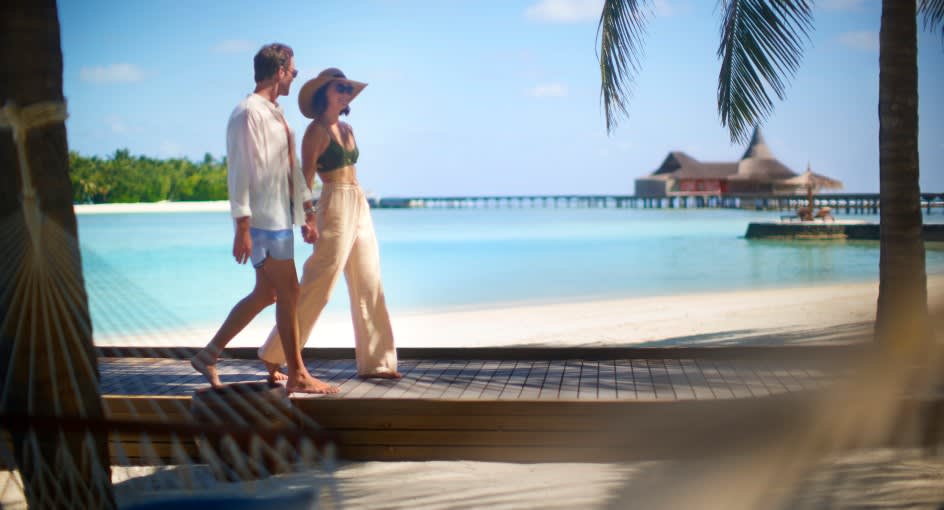 Couple walking in the island at Anantara Veli Maldives Adults Only Resort