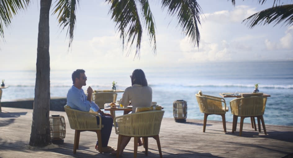 Couple enjoying meals at Cumin Restaurant terrace at Anantara Veli Maldives Resort