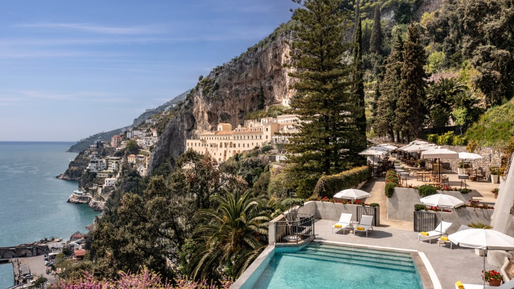 A view of the hotel pool and ocean at Anantara Convento Di Amalfi Grand Hotel.