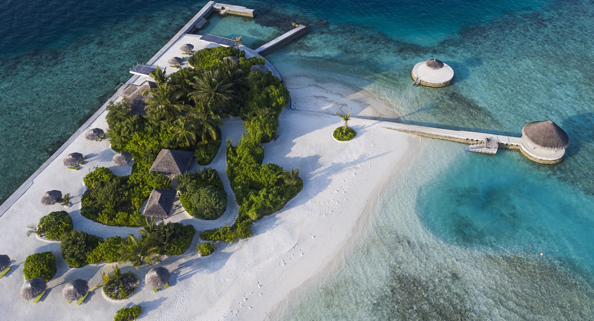 Aerial view of Gulhifushi Picnic Island at Anantara Dhigu Maldives Resort, showcasing its pristine white sands and turquoise lagoon