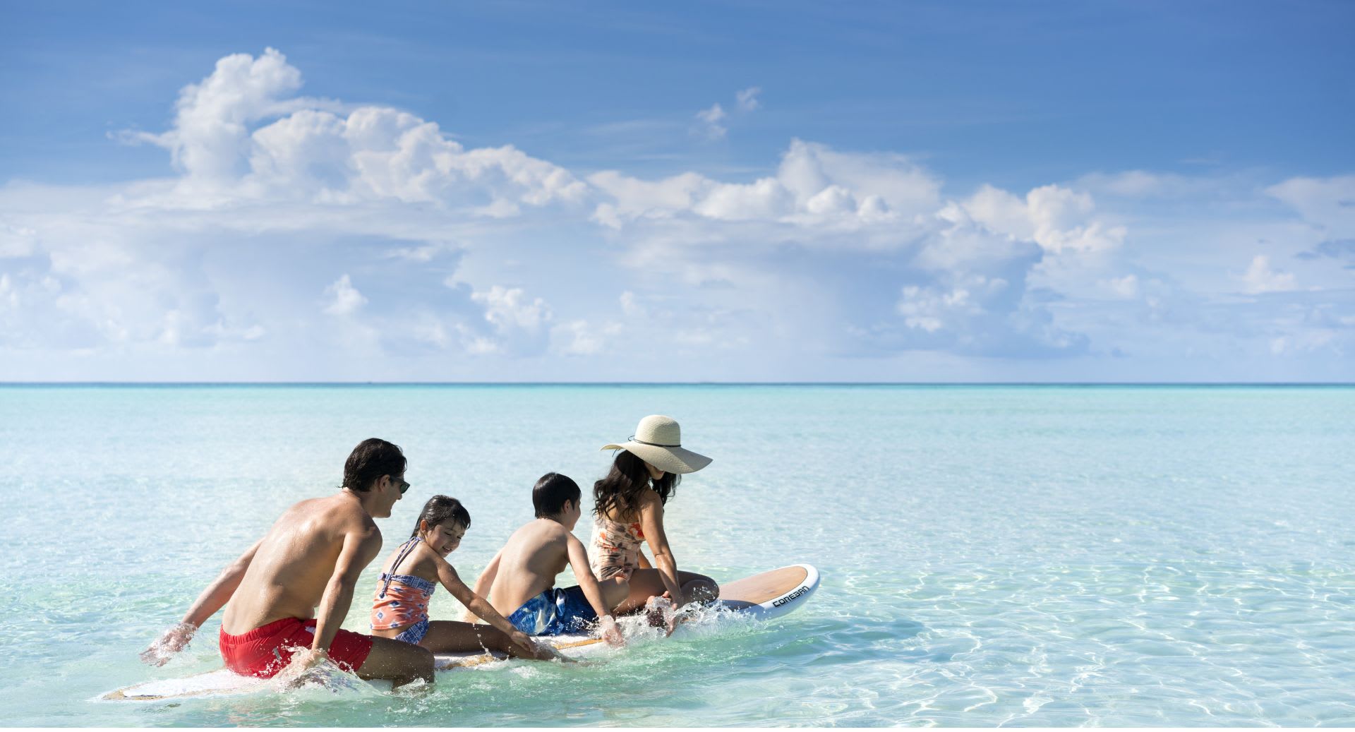Paddleboard family watersport activity at Anantara Dhigu Maldives Resort
