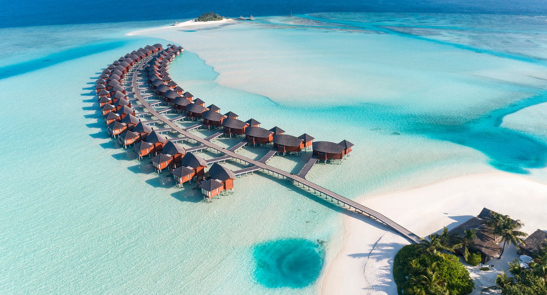 Aerial view of the overwater villas at Anantara Dhigu Maldives Resort