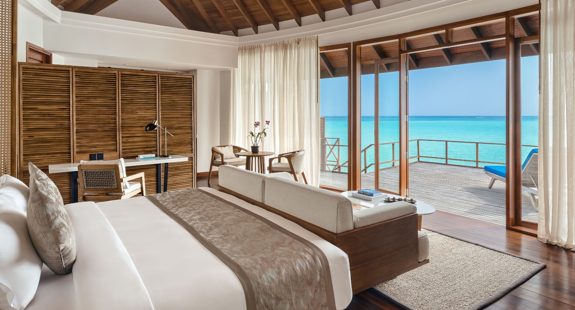 Guest bedroom view of the Sunset Overwater Villa at Anantara Dhigu Maldives Resort