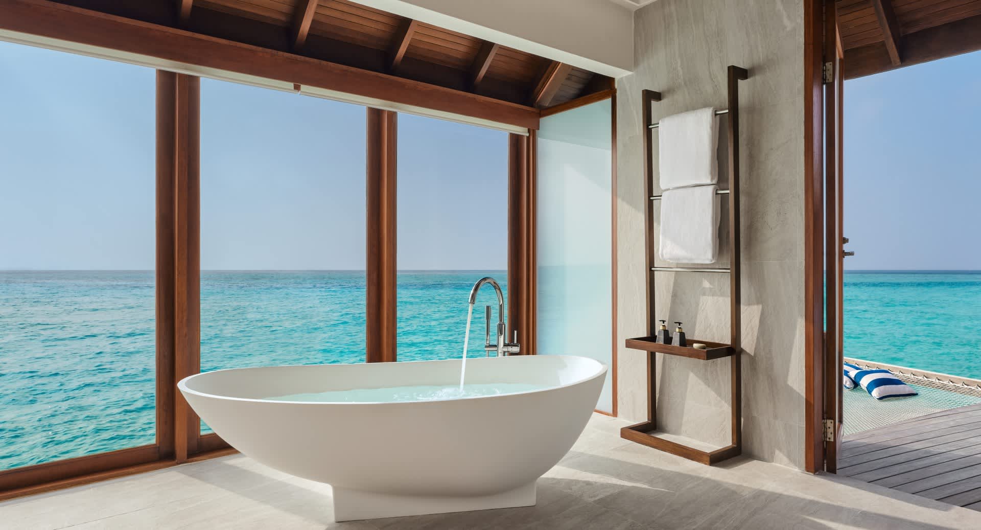 Sunset Over Water Villa Bathroom with Bathtub at Anantara Dhigu Maldives Resort