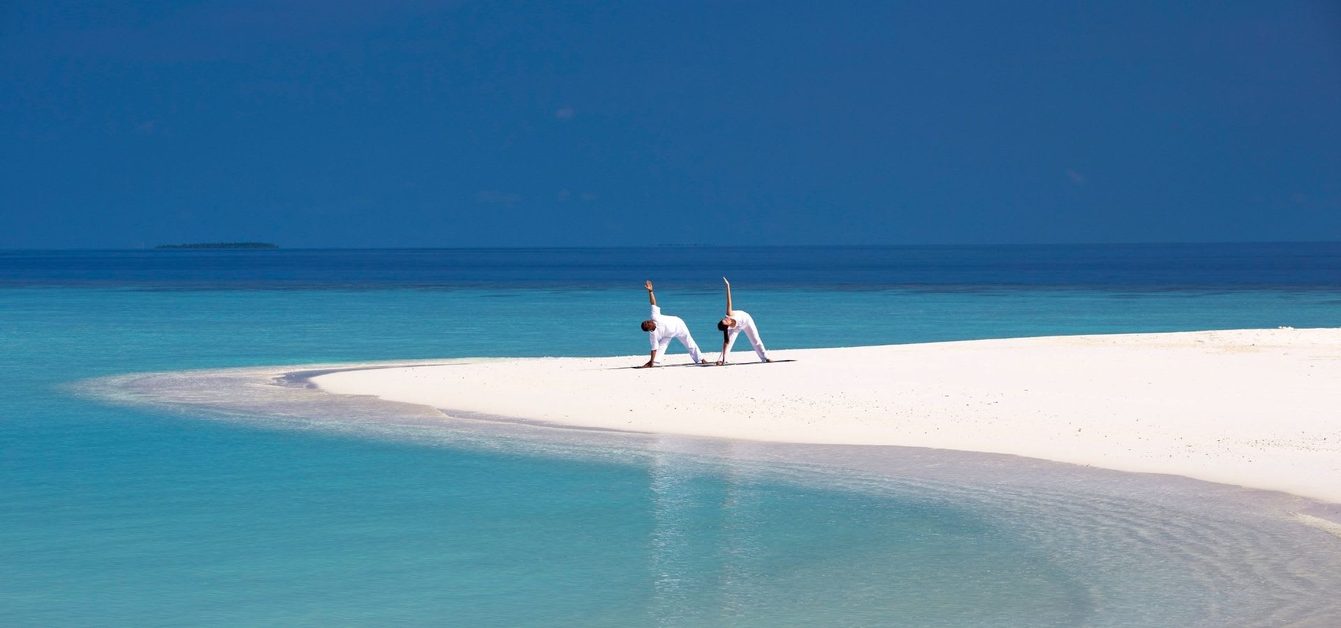 Yoga on the beach at Anantara Kihavah Maldives