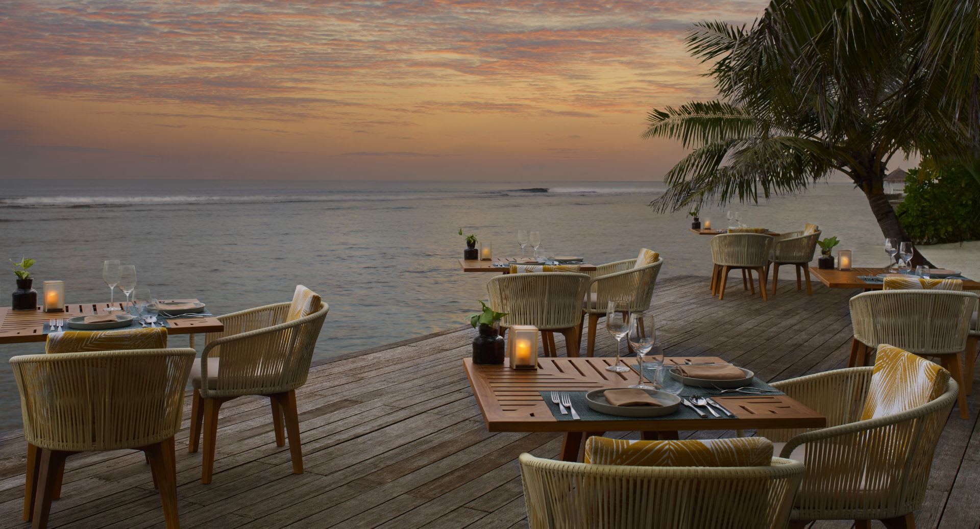Cumin restaurant deck at dusk, at Anantara Veli Maldives Resort