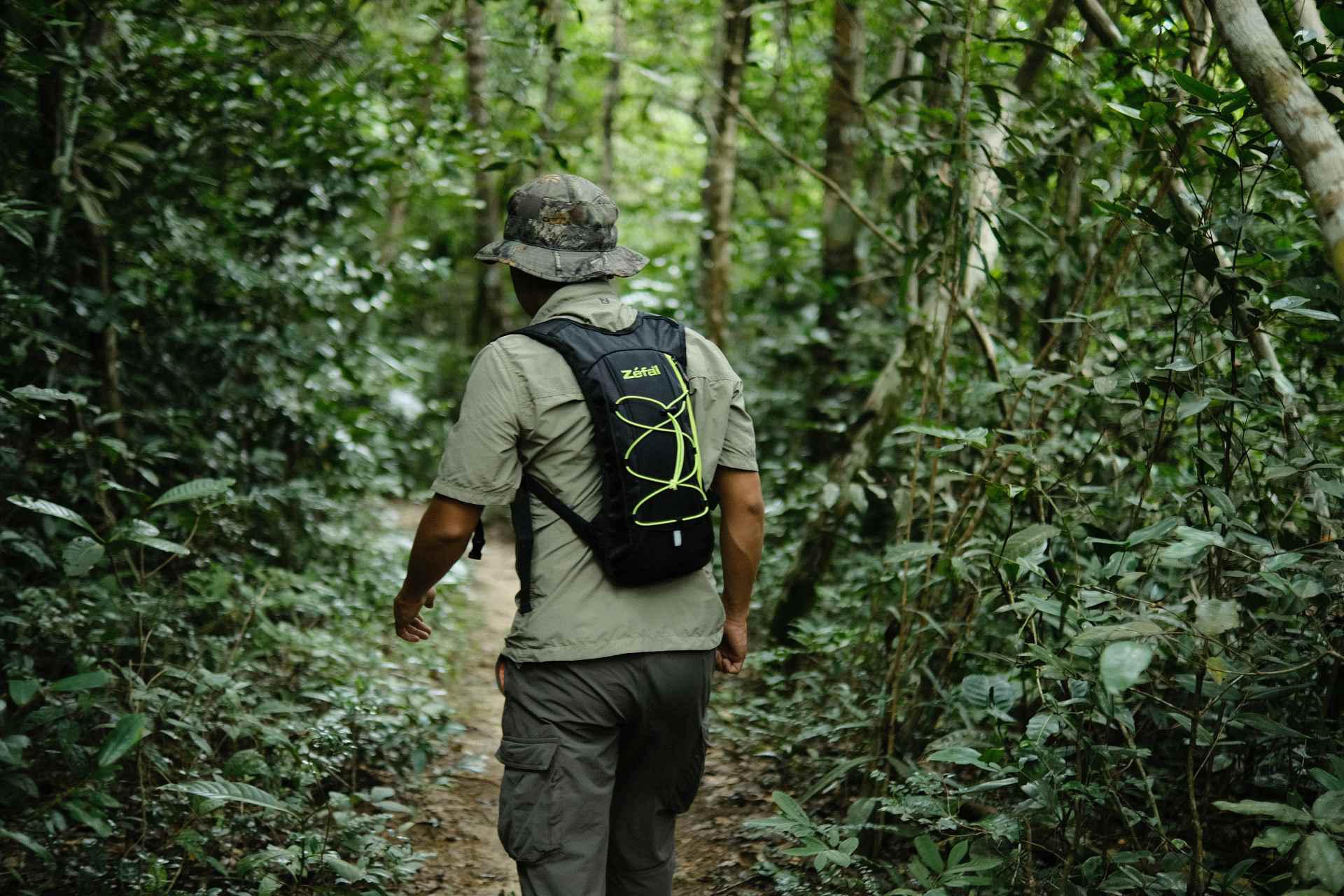A man hiking in the jungles of Kulen Mountain.