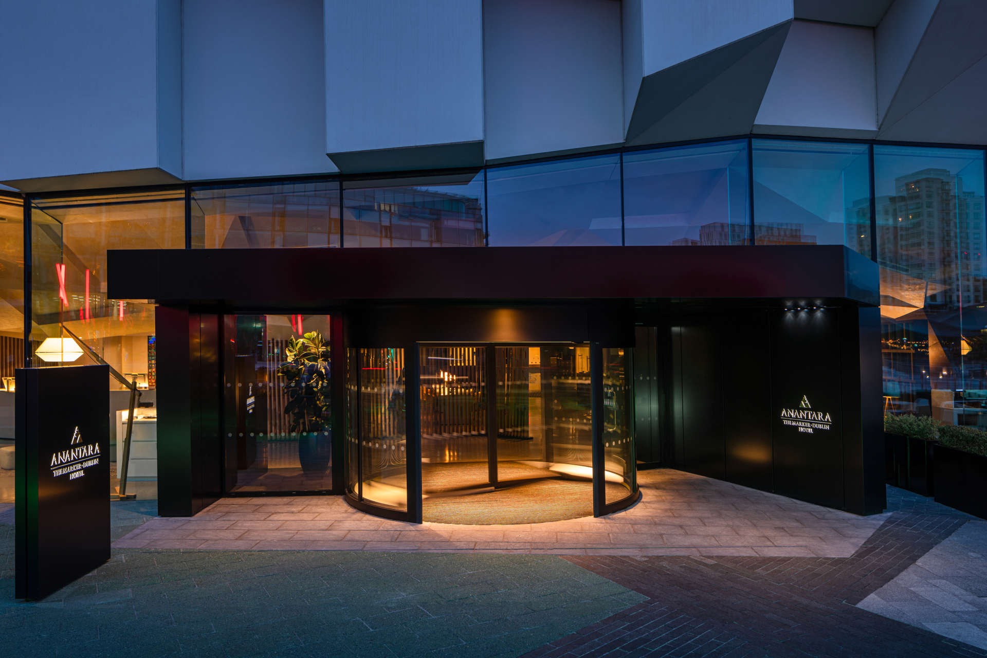 The entrance at Anantara The Marker Dublin Hotel at night.