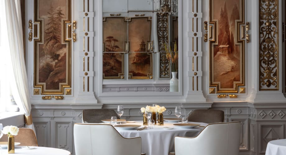 Luxurious fine-dining interior with ornate walls, white tablecloths, and floral arrangements. Inspired by Chef Jacob Jan Boerma’s Michelin-starred restaurant at Anantara.