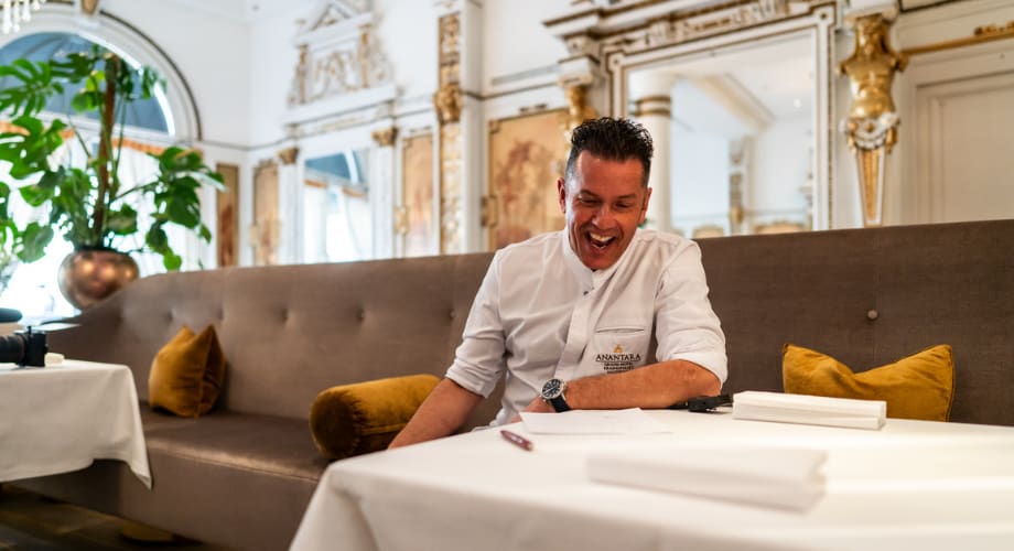 Close-up of Chef Jacob Jan Boerma at Anantara dining, writing a new perfume inspired menu.