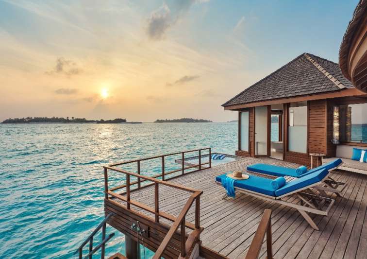 Exterior sunrise view of the Over Water Villa Deck with Loungers at Anantara Dhigu Maldives Resort