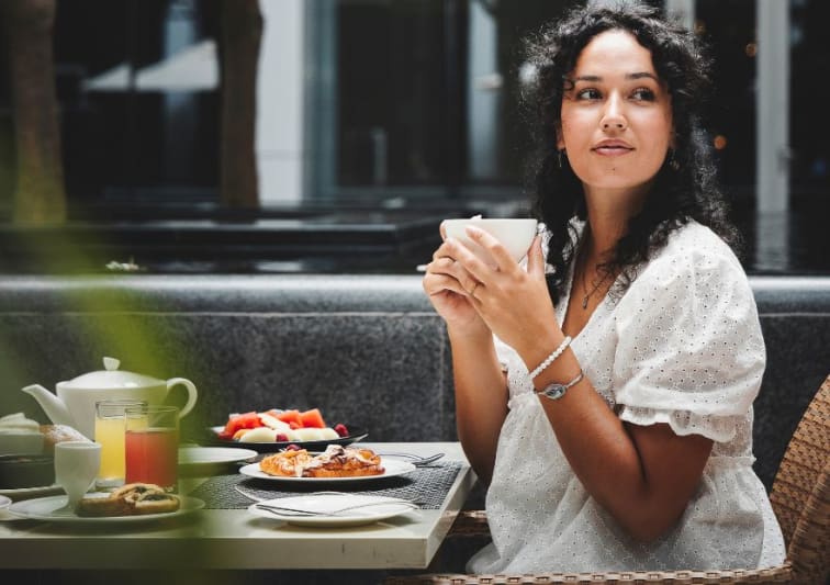 A lady enjoying breakfast at Anantara Downtown Nine7One