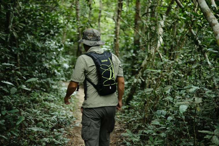 A man hiking in the jungles of Kulen Mountain.