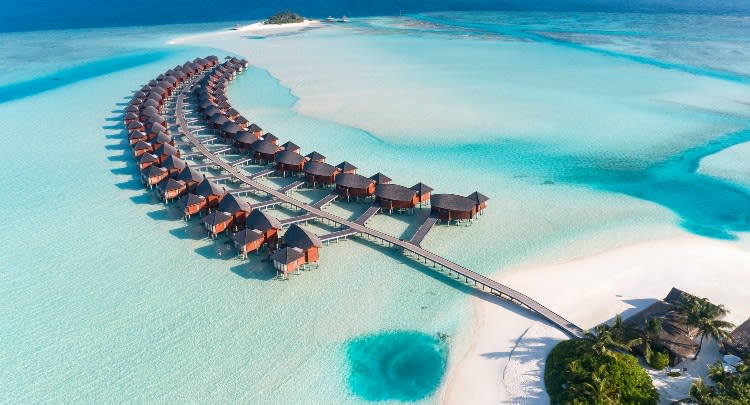 Aerial view of over water suites at Anantara Dhigu Maldives Resort