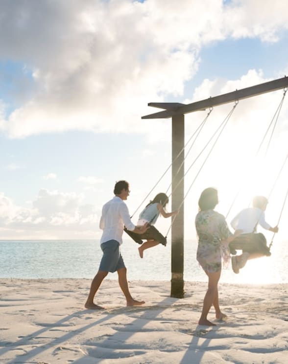 Family swing on the beach at Anantara Dhigu Maldives