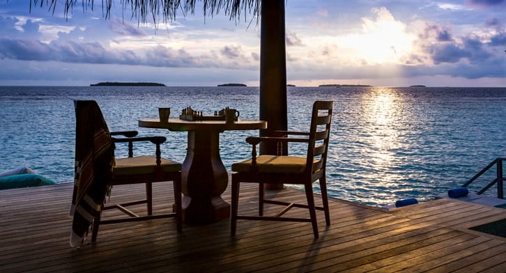 Dining at Anantara Kihavah Luxury Sunset Over Water Pool Villa