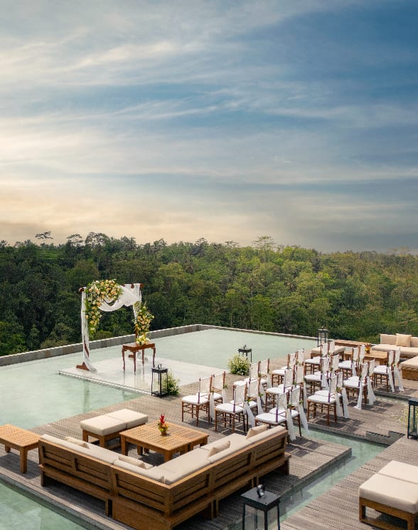 Elegant weddings set on a stage where water, jungle, clouds, and the sacred Mount Agung swirl together on the horizon